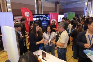 SAGESOFT and OutSystems team engaging with government attendees at the National ICT Summit 2026 Caption: The SAGESOFT and OutSystems team in conversation with government technology leaders at the summit exhibit floor.